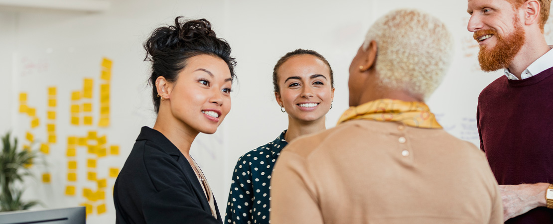 A group of people talking in an office
